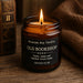 Old Bookshop candle by Cosy Art London styled on wood slice with glowing flame, surrounded by vintage books and warm autumn tones. Handmade in London.
